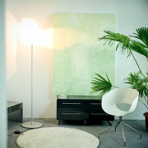 cry-25ss-interior-sunlight-chair-painting-plant Interior scene from CRY 25SS Lookbook featuring a white chair, wall cabinet, large painting, green plant, and warm sunlight, evoking a calm and nostalgic lifestyle mood